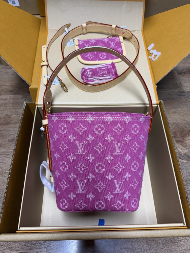 The Louis Vuitton Vanity Small Handbag (Vanity Case style) is crafted from the brand's classic Monogram-printed pink denim canvas, accented with natural cowhide trim and gold-tone hardware.