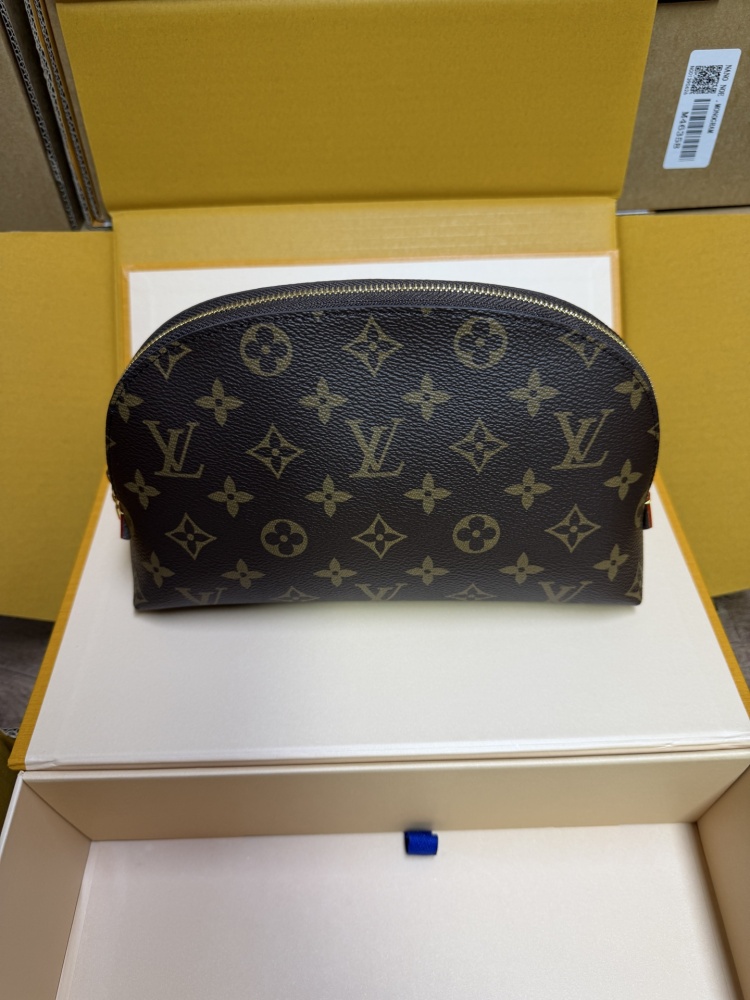 The classic Louis Vuitton Cosmetic Pouch features the brand's iconic Monogram coated canvas.