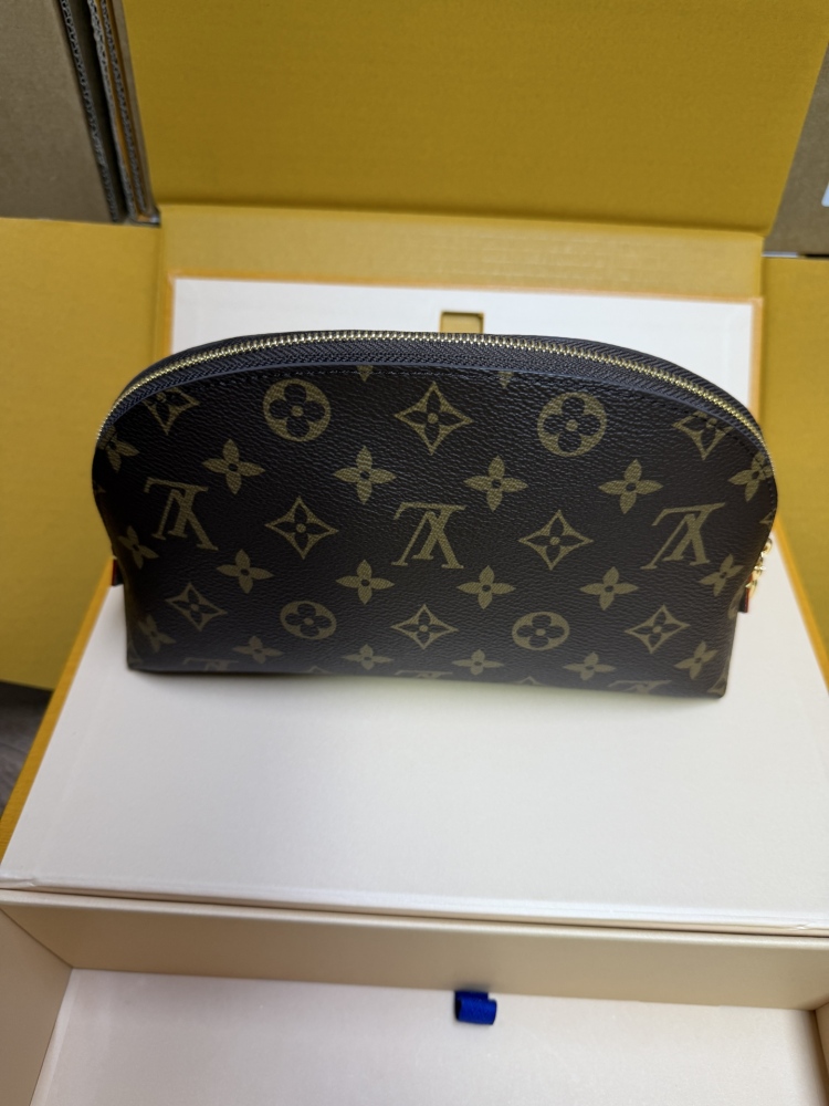 The classic Louis Vuitton Cosmetic Pouch features the brand's iconic Monogram coated canvas.