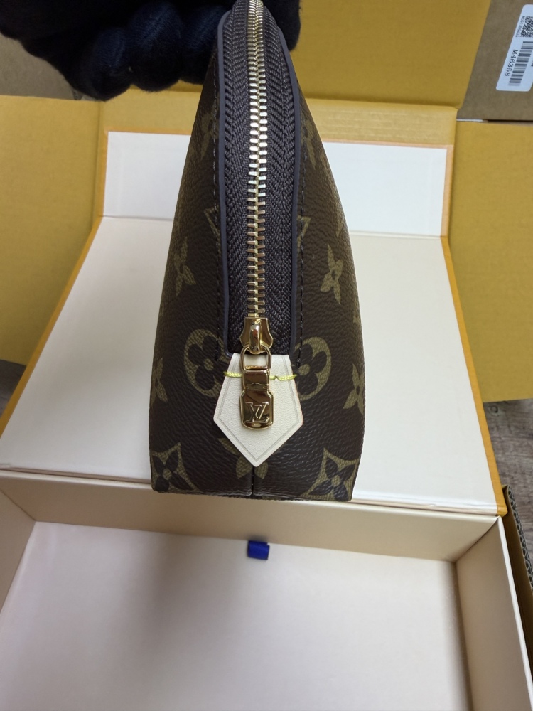 The classic Louis Vuitton Cosmetic Pouch features the brand's iconic Monogram coated canvas.