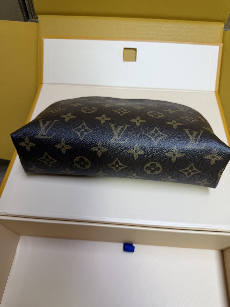 The classic Louis Vuitton Cosmetic Pouch features the brand's iconic Monogram coated canvas.