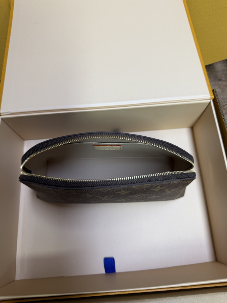 The classic Louis Vuitton Cosmetic Pouch features the brand's iconic Monogram coated canvas.