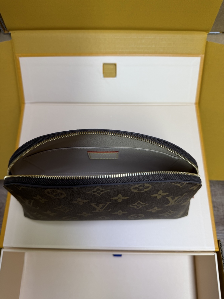 The classic Louis Vuitton Cosmetic Pouch features the brand's iconic Monogram coated canvas.