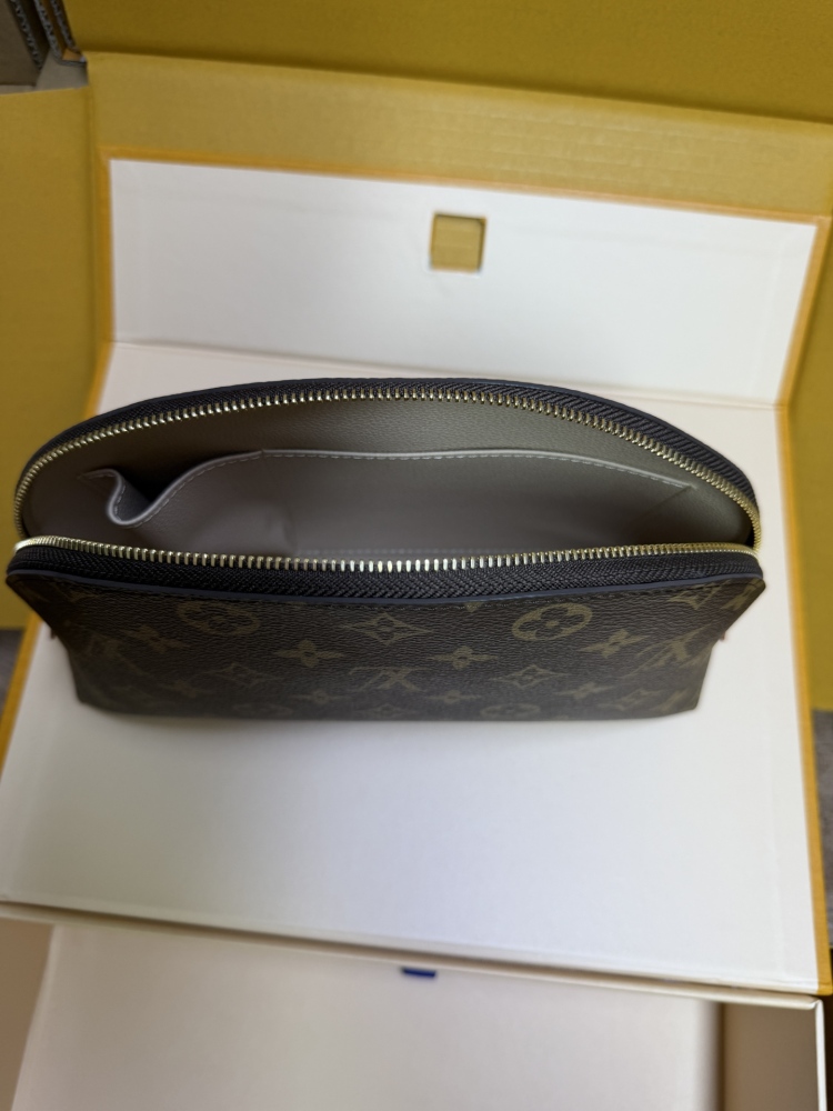 The classic Louis Vuitton Cosmetic Pouch features the brand's iconic Monogram coated canvas.