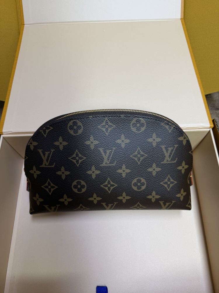 The classic Louis Vuitton Cosmetic Pouch features the brand's iconic Monogram coated canvas.