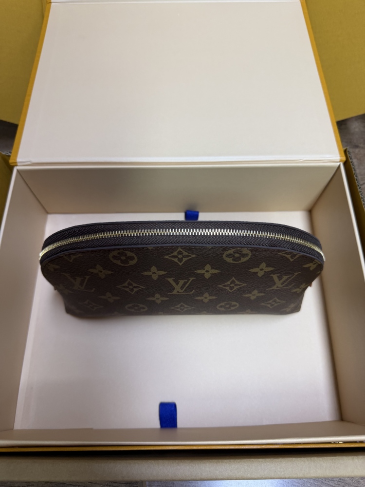 The classic Louis Vuitton Cosmetic Pouch features the brand's iconic Monogram coated canvas.