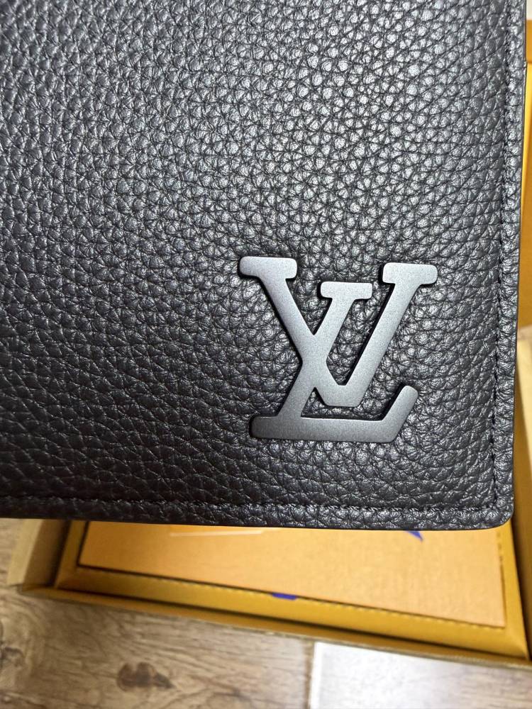 The Louis Vuitton LV Aerogram long bi-fold wallet is crafted from grained cowhide leather, a material specifically developed by the brand for men.