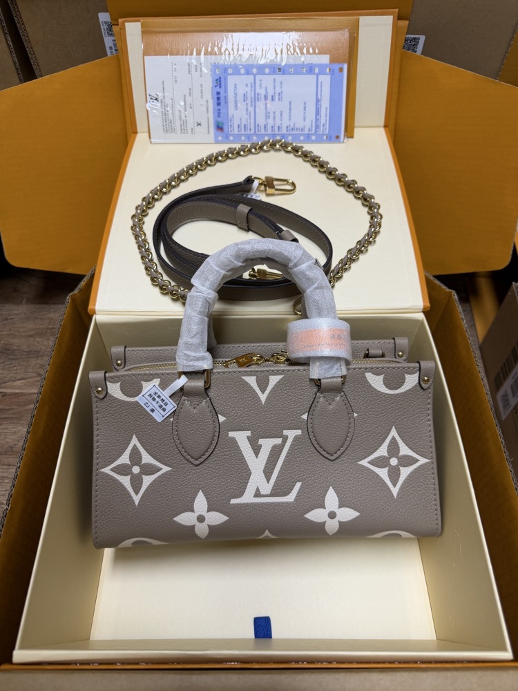 Louis Vuitton OnTheGo East-West Small Handbag, featuring a Grey/White colorway in Monogram Empreinte embossed cowhide.