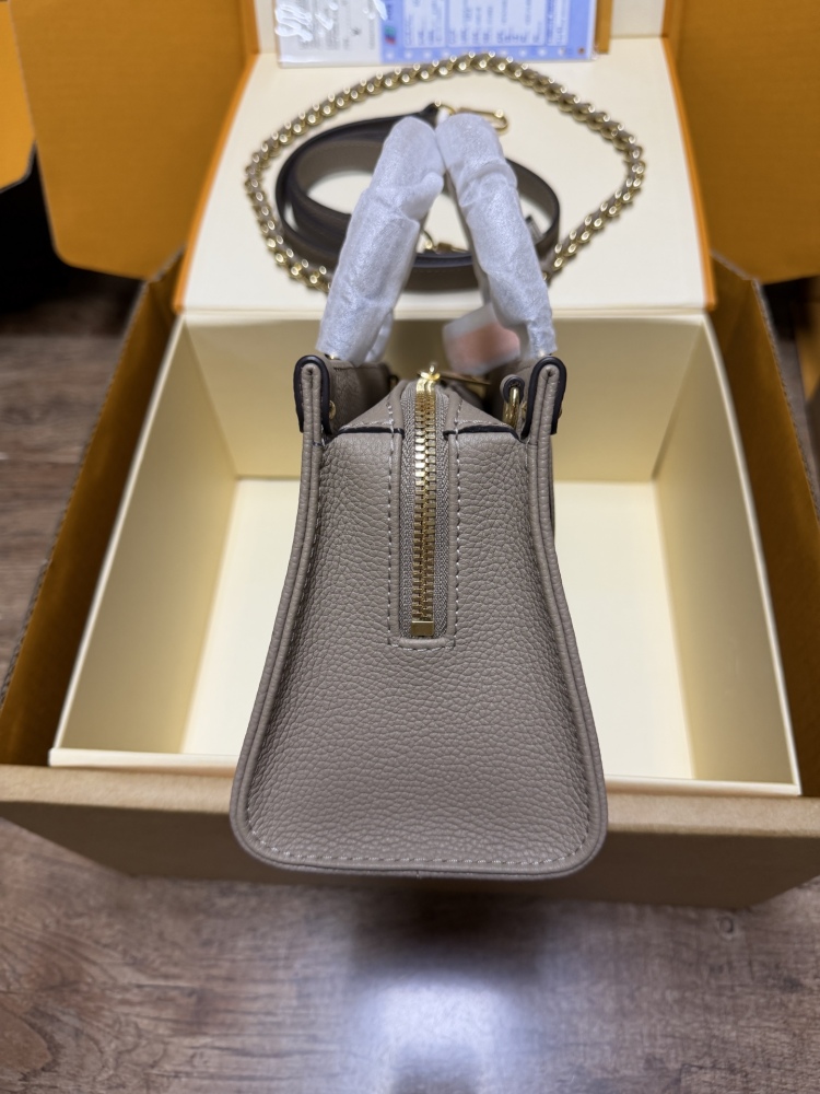 Louis Vuitton OnTheGo East-West Small Handbag, featuring a Grey/White colorway in Monogram Empreinte embossed cowhide.