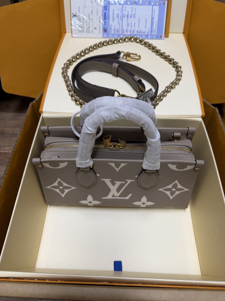 Louis Vuitton OnTheGo East-West Small Handbag, featuring a Grey/White colorway in Monogram Empreinte embossed cowhide.