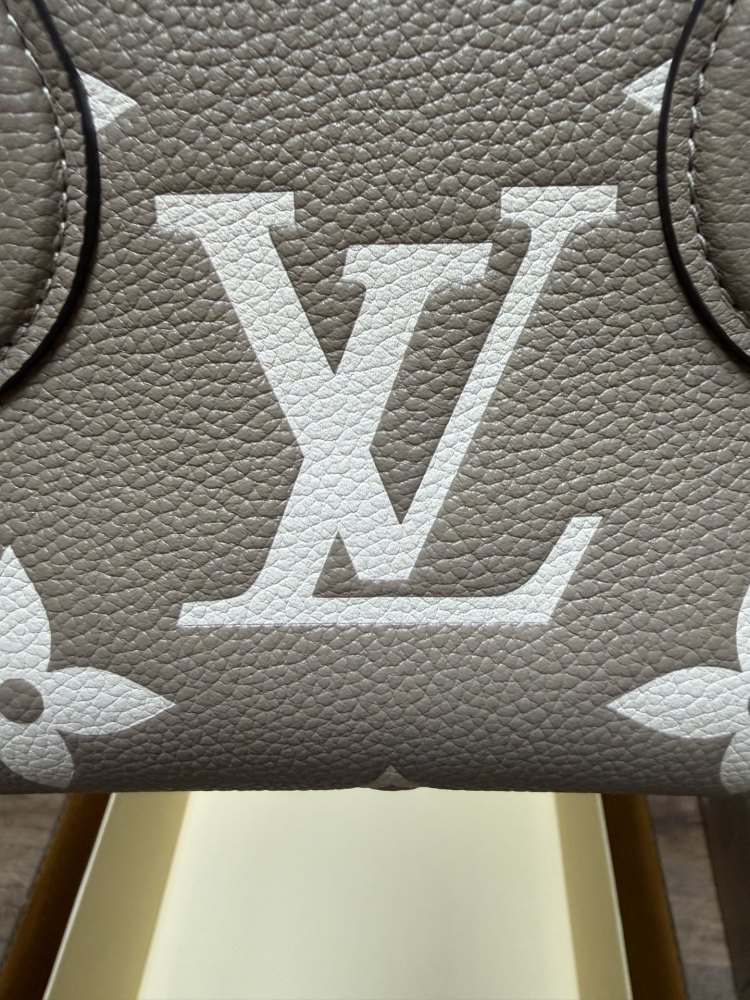 Louis Vuitton OnTheGo East-West Small Handbag, featuring a Grey/White colorway in Monogram Empreinte embossed cowhide.