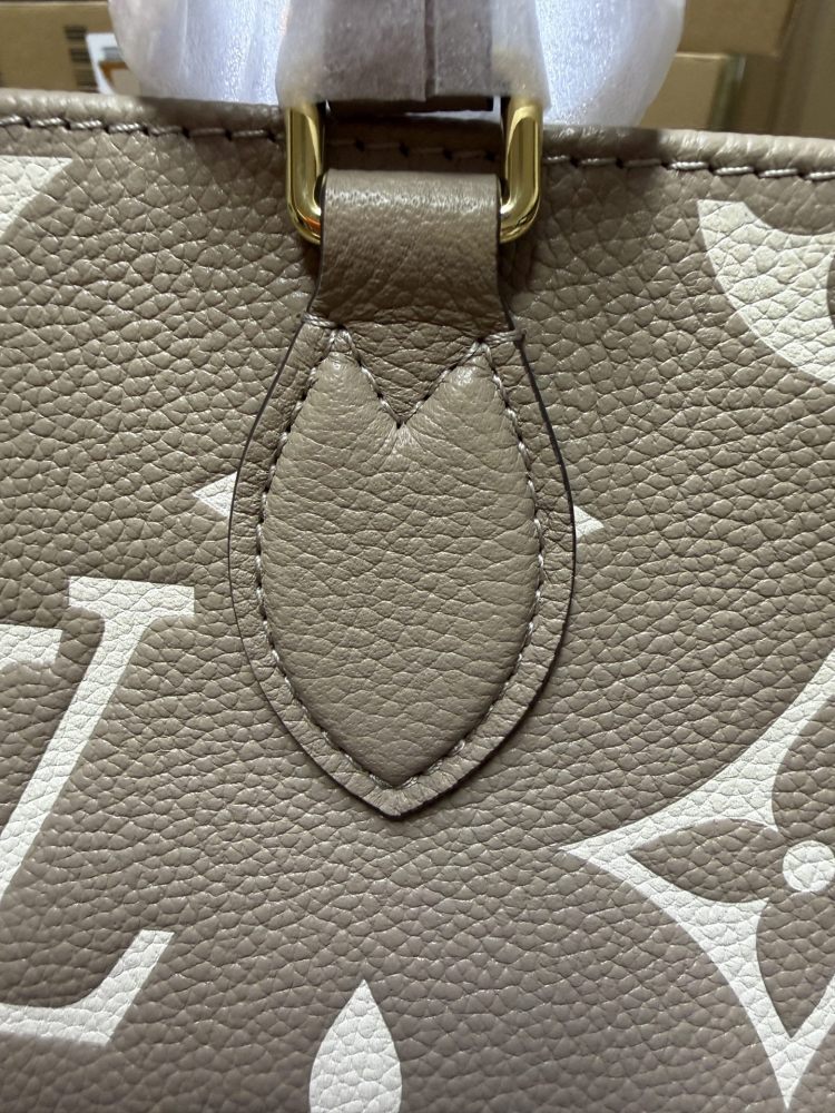Louis Vuitton OnTheGo East-West Small Handbag, featuring a Grey/White colorway in Monogram Empreinte embossed cowhide.