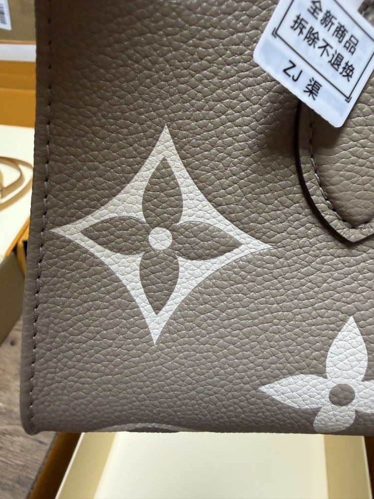 Louis Vuitton OnTheGo East-West Small Handbag, featuring a Grey/White colorway in Monogram Empreinte embossed cowhide.