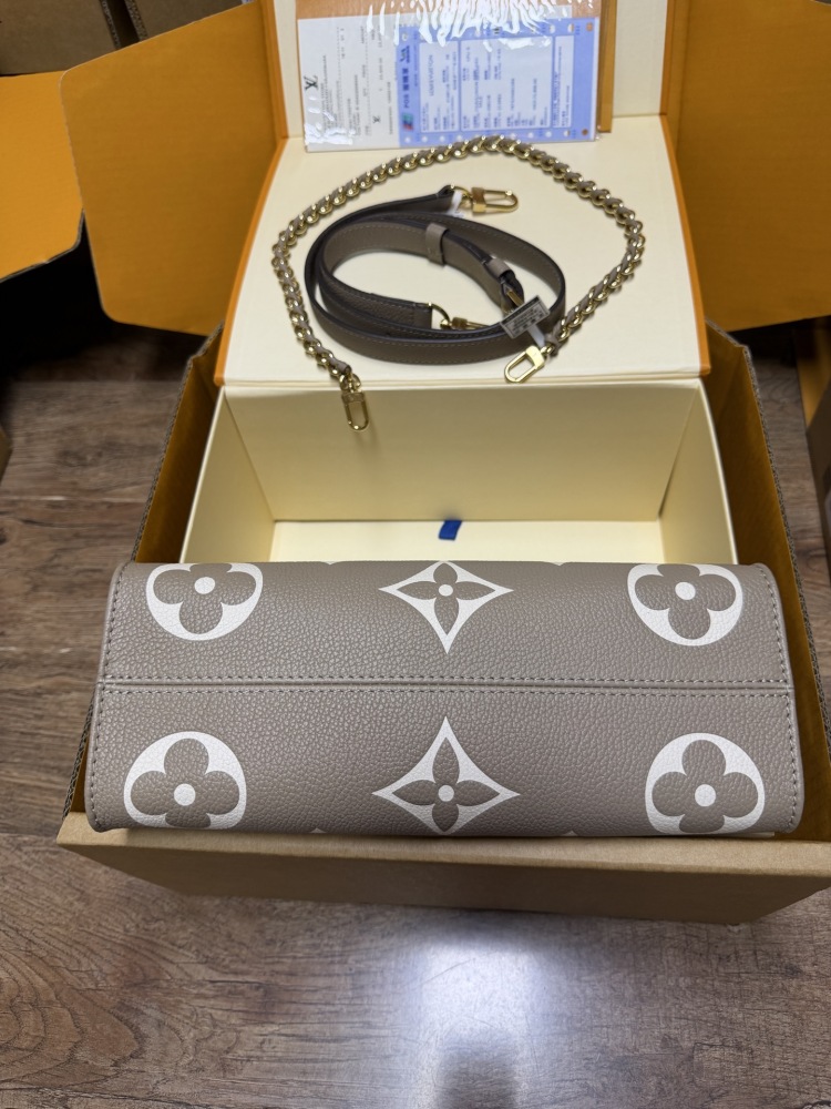 Louis Vuitton OnTheGo East-West Small Handbag, featuring a Grey/White colorway in Monogram Empreinte embossed cowhide.