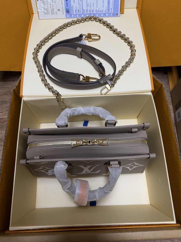 Louis Vuitton OnTheGo East-West Small Handbag, featuring a Grey/White colorway in Monogram Empreinte embossed cowhide.