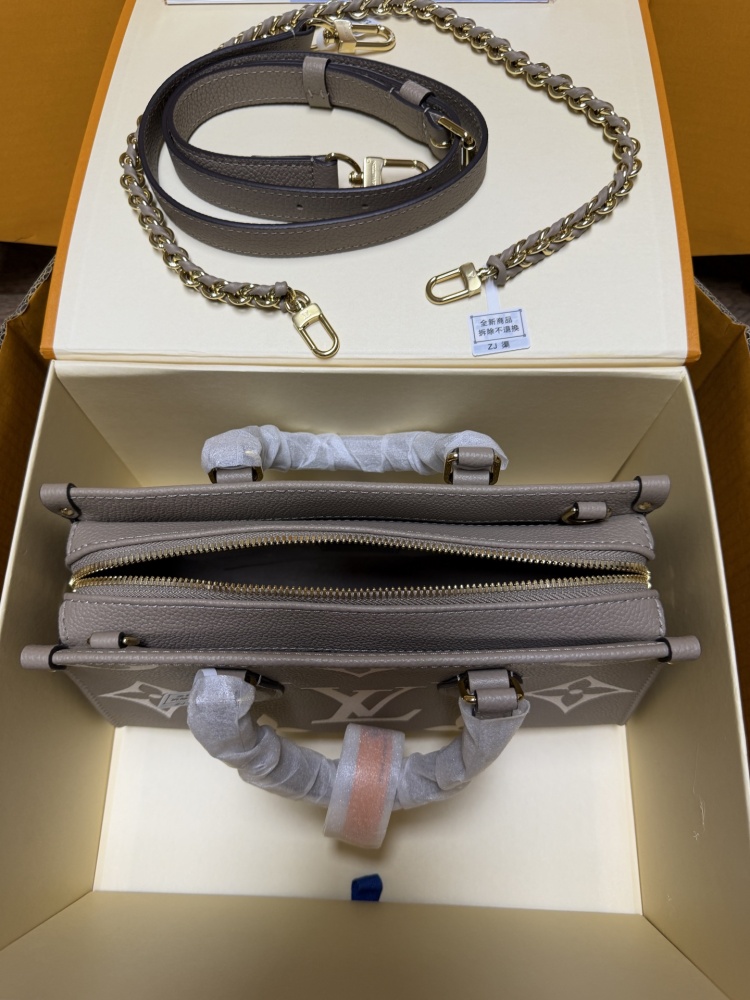 Louis Vuitton OnTheGo East-West Small Handbag, featuring a Grey/White colorway in Monogram Empreinte embossed cowhide.