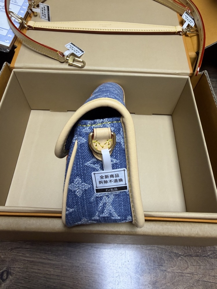 The Louis Vuitton Nano Diane mini baguette bag features the brand's iconic Monogram denim canvas.