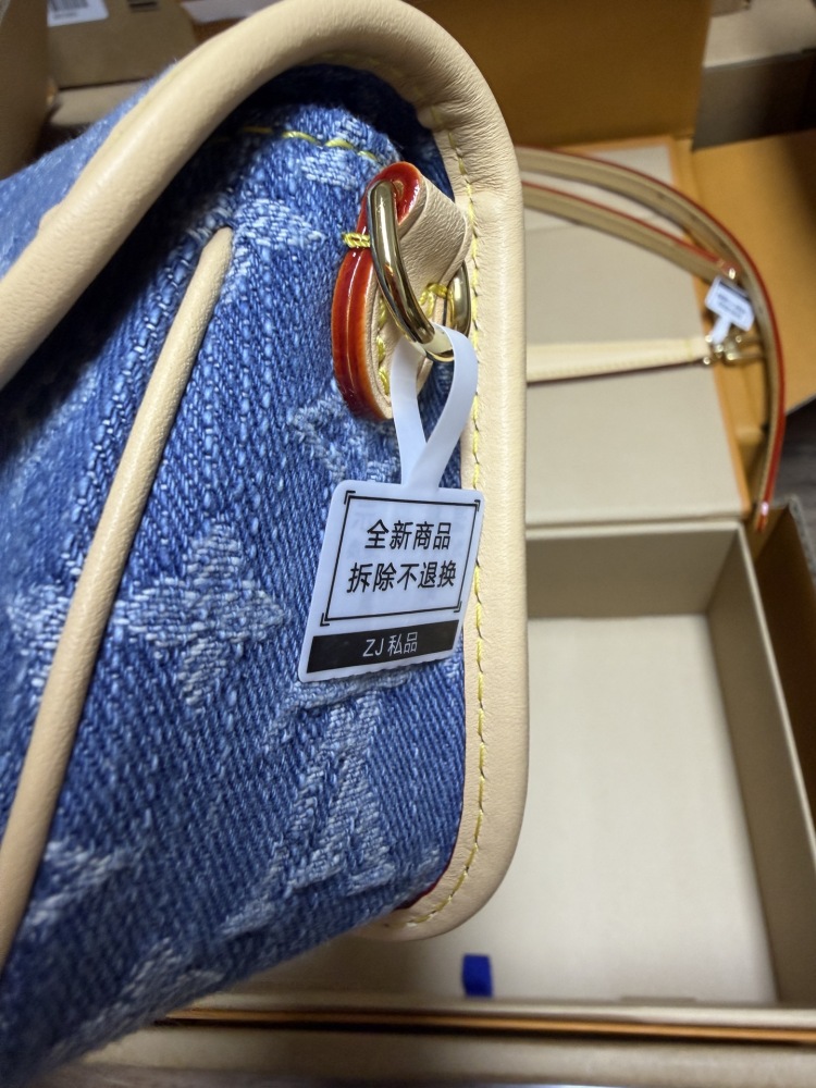The Louis Vuitton Nano Diane mini baguette bag features the brand's iconic Monogram denim canvas.