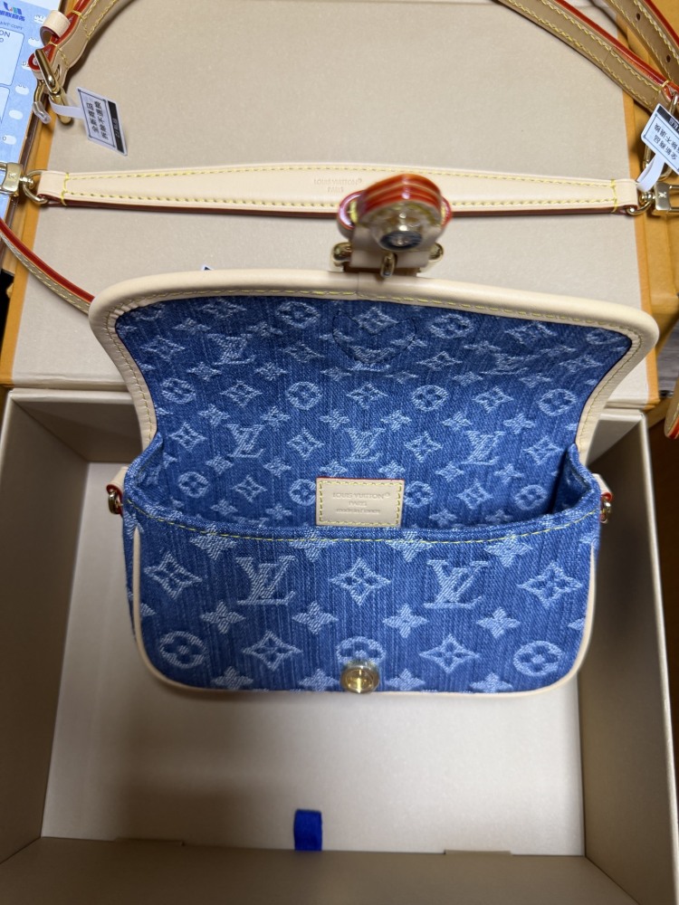 The Louis Vuitton Nano Diane mini baguette bag features the brand's iconic Monogram denim canvas.
