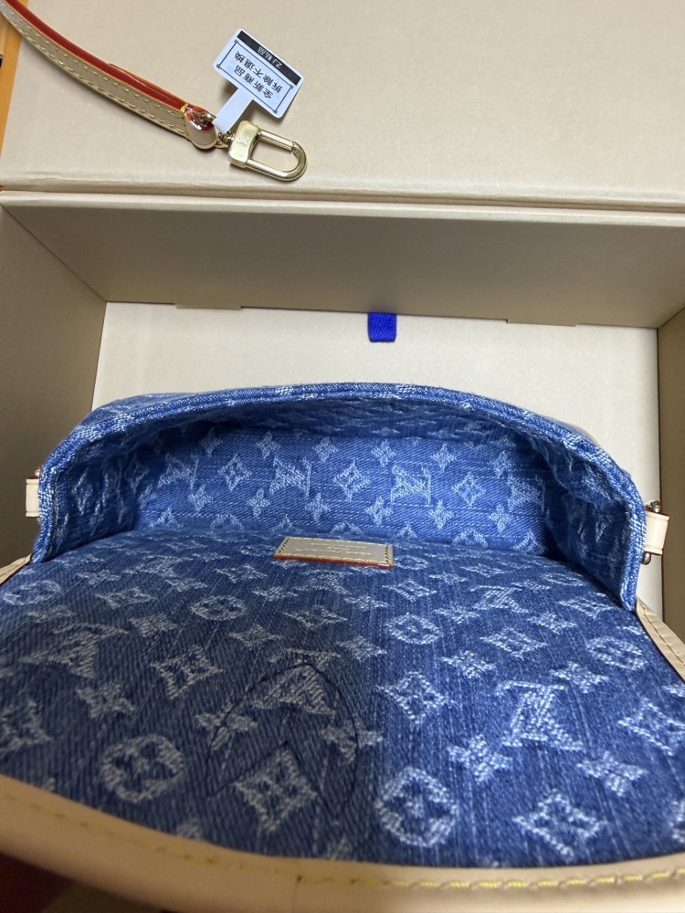 The Louis Vuitton Nano Diane mini baguette bag features the brand's iconic Monogram denim canvas.