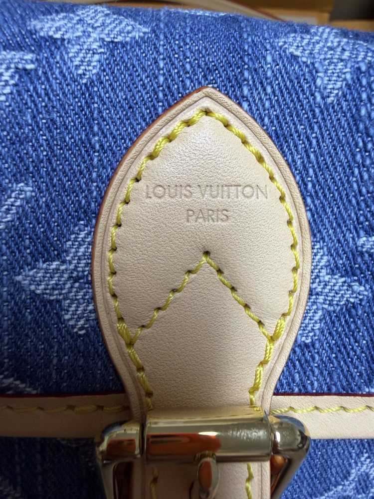 The Louis Vuitton Nano Diane mini baguette bag features the brand's iconic Monogram denim canvas.