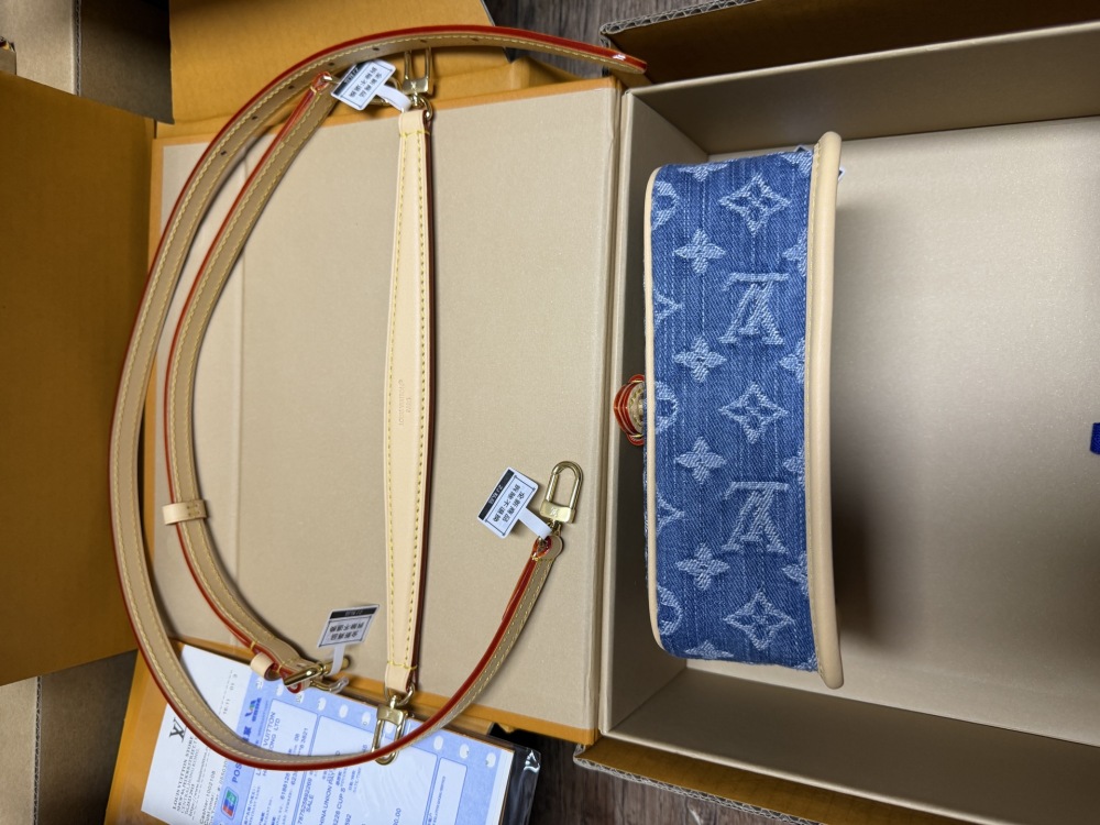The Louis Vuitton Nano Diane mini baguette bag features the brand's iconic Monogram denim canvas.