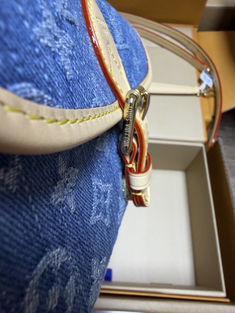 The Louis Vuitton Nano Diane mini baguette bag features the brand's iconic Monogram denim canvas.
