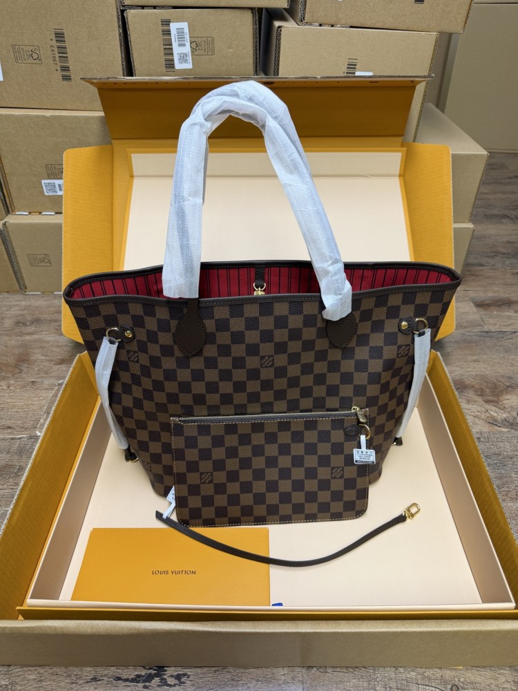 The Louis Vuitton Neverfull MM medium tote bag features the classic Damier Ebene brown checkered canvas, paired with the iconic red striped lining.