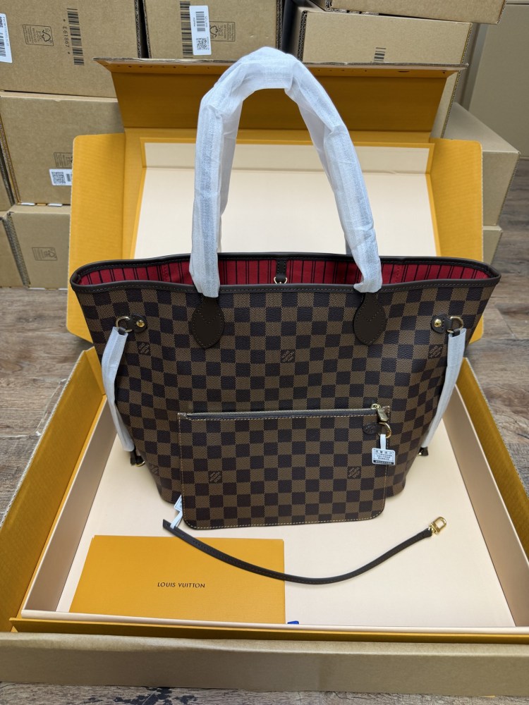 The Louis Vuitton Neverfull MM medium tote bag features the classic Damier Ebene brown checkered canvas, paired with the iconic red striped lining.