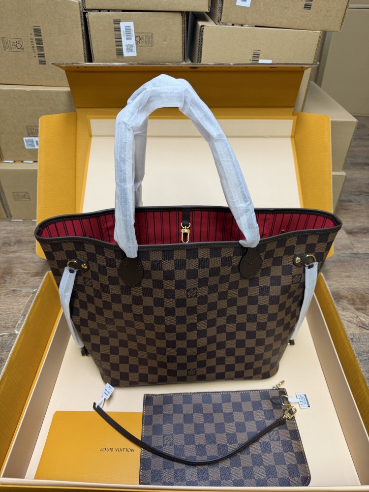 The Louis Vuitton Neverfull MM medium tote bag features the classic Damier Ebene brown checkered canvas, paired with the iconic red striped lining.