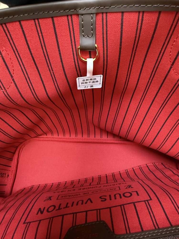 The Louis Vuitton Neverfull MM medium tote bag features the classic Damier Ebene brown checkered canvas, paired with the iconic red striped lining.