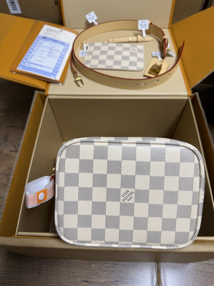 The Louis Vuitton Nano Bucket bag features the brand's classic Damier Azur white checkered canvas, paired with a light blue lining.