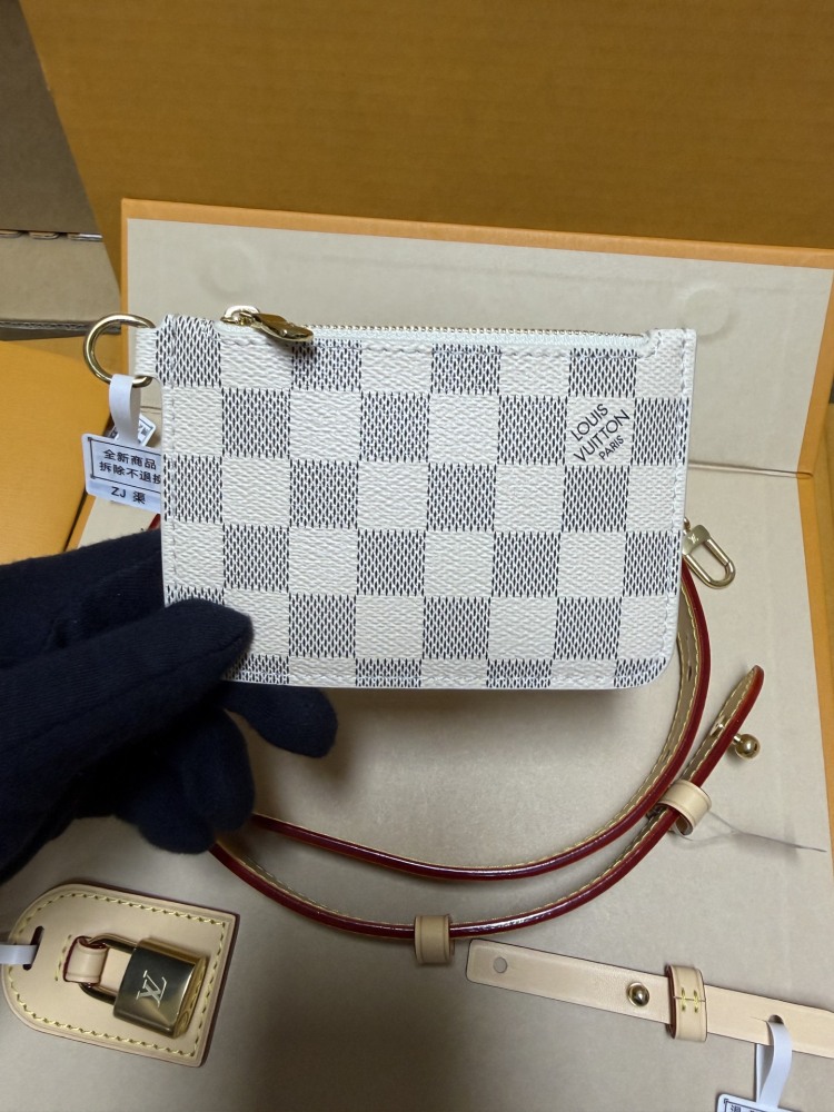 The Louis Vuitton Nano Bucket bag features the brand's classic Damier Azur white checkered canvas, paired with a light blue lining.