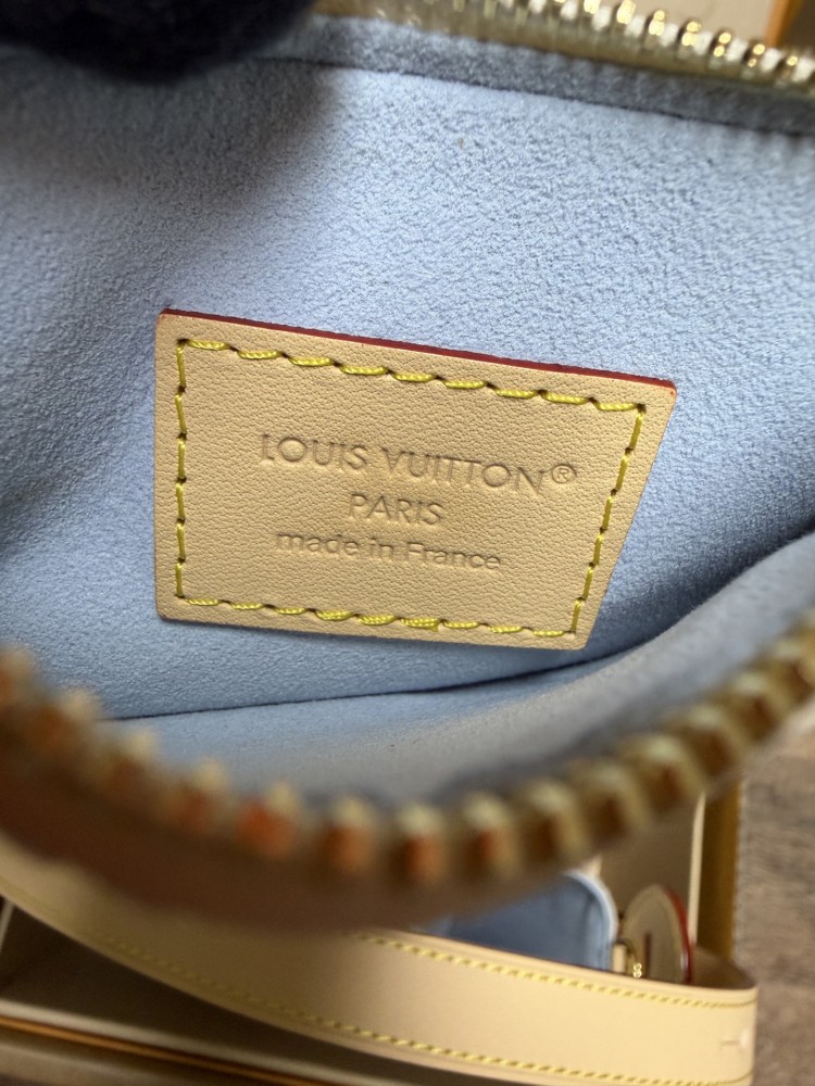 The Louis Vuitton Nano Bucket bag features the brand's classic Damier Azur white checkered canvas, paired with a light blue lining.
