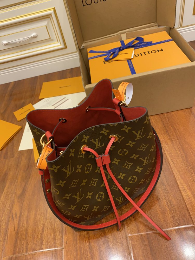 The Louis Vuitton NéoNoé MM bucket bag features the classic Monogram canvas, paired with a vibrant red lining and drawstring.