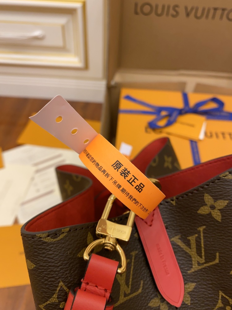 The Louis Vuitton NéoNoé MM bucket bag features the classic Monogram canvas, paired with a vibrant red lining and drawstring.