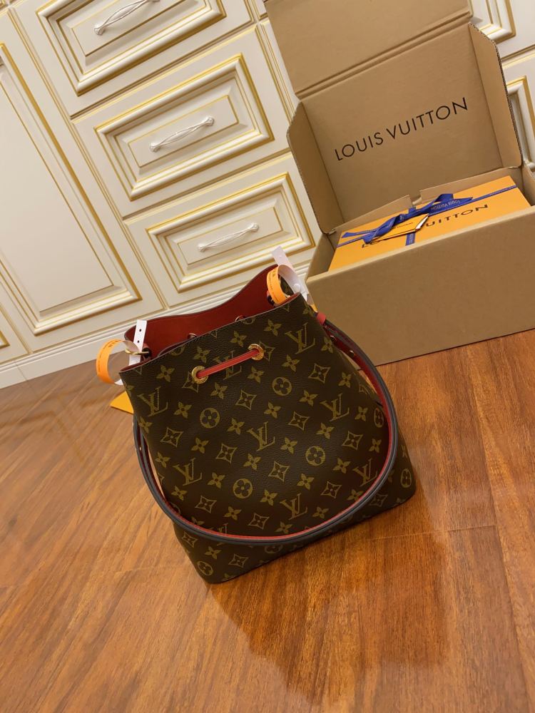 The Louis Vuitton NéoNoé MM bucket bag features the classic Monogram canvas, paired with a vibrant red lining and drawstring.