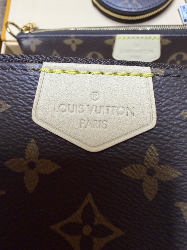 The Louis Vuitton Multi Pochette Accessoires features the brand's classic Monogram canvas, paired with a popular wide green shoulder strap.