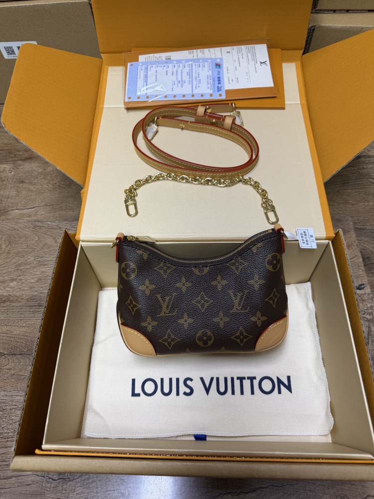 The Louis Vuitton LV Mini Hobo—often referred to as the "Moon Bag"—is crafted from the brand's classic Monogram canvas.