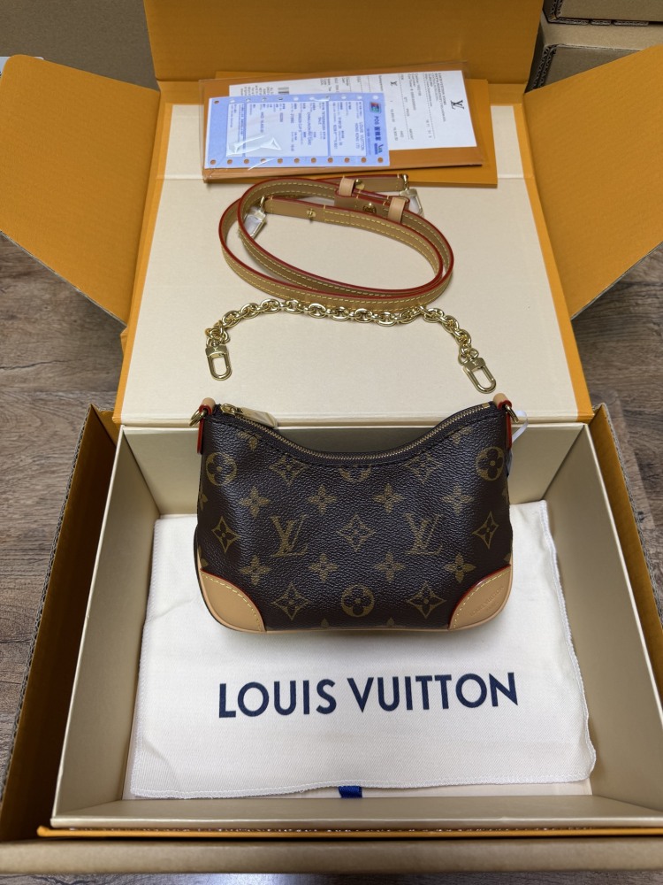 The Louis Vuitton LV Mini Hobo—often referred to as the "Moon Bag"—is crafted from the brand's classic Monogram canvas.