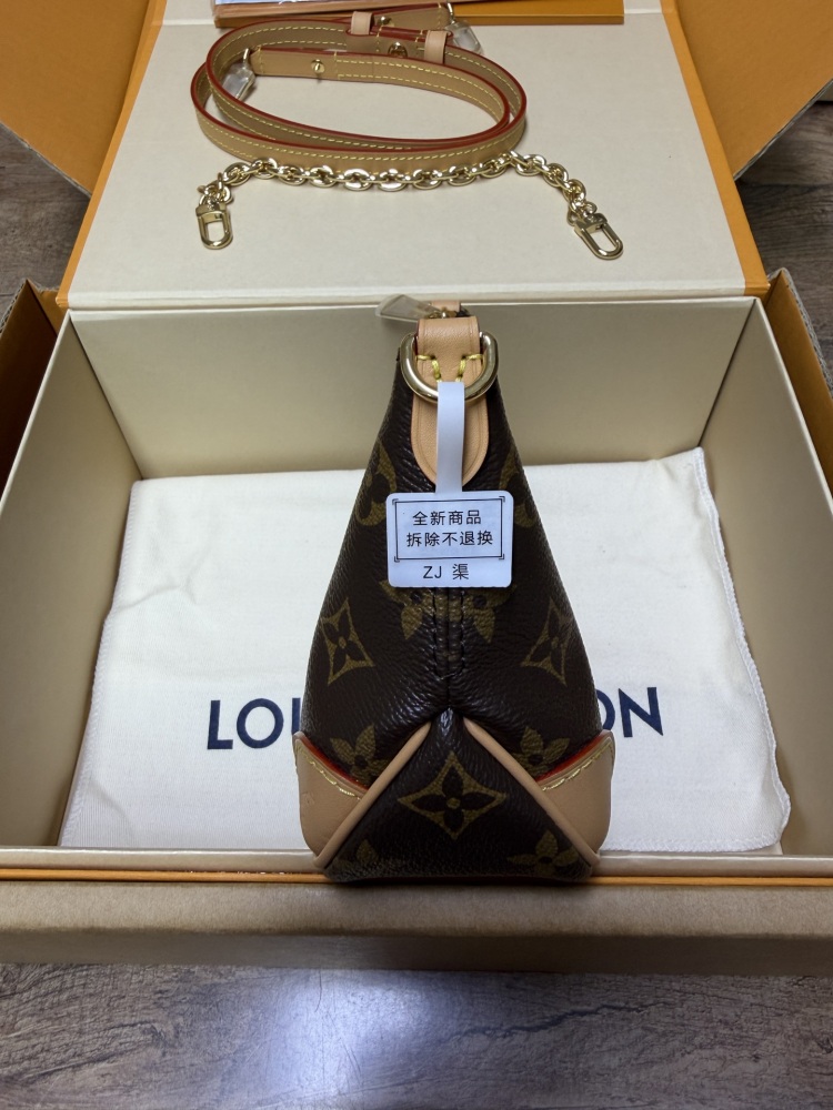 The Louis Vuitton LV Mini Hobo—often referred to as the "Moon Bag"—is crafted from the brand's classic Monogram canvas.