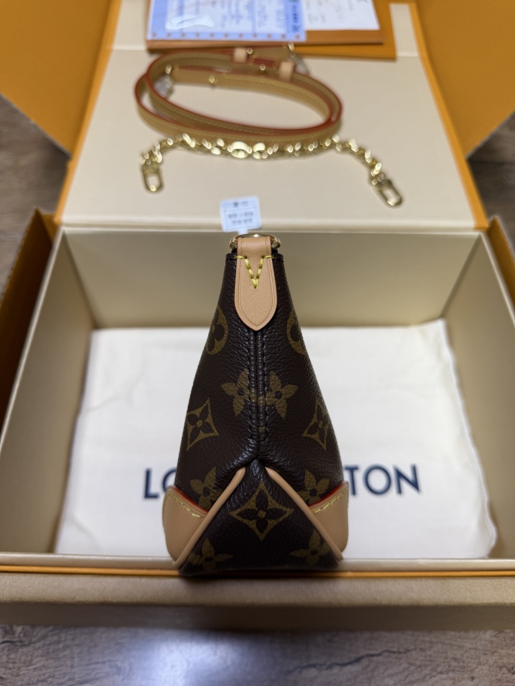The Louis Vuitton LV Mini Hobo—often referred to as the "Moon Bag"—is crafted from the brand's classic Monogram canvas.
