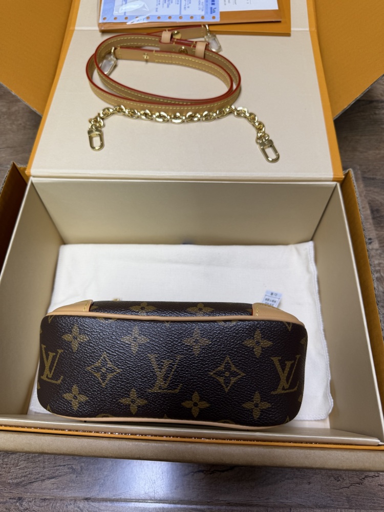 The Louis Vuitton LV Mini Hobo—often referred to as the "Moon Bag"—is crafted from the brand's classic Monogram canvas.
