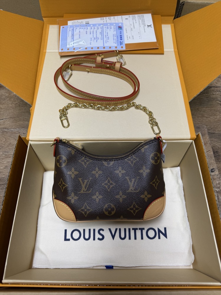 The Louis Vuitton LV Mini Hobo—often referred to as the "Moon Bag"—is crafted from the brand's classic Monogram canvas.