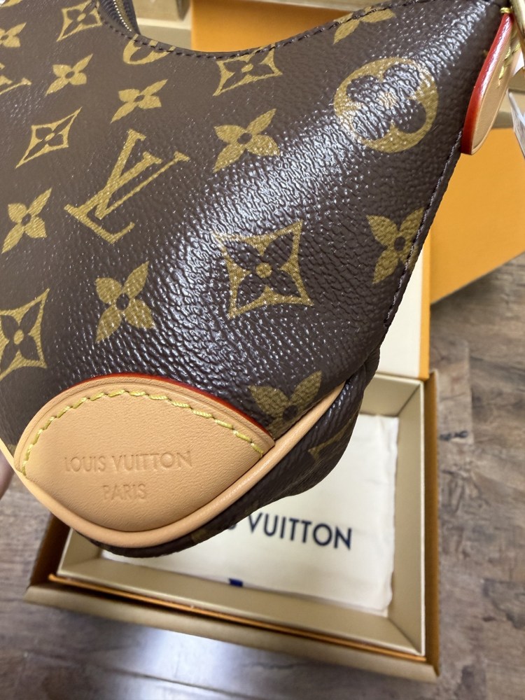 The Louis Vuitton LV Mini Hobo—often referred to as the "Moon Bag"—is crafted from the brand's classic Monogram canvas.