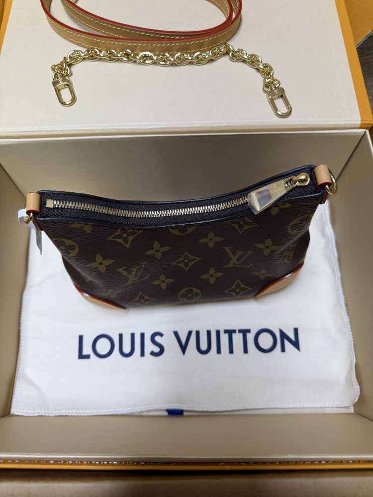The Louis Vuitton LV Mini Hobo—often referred to as the "Moon Bag"—is crafted from the brand's classic Monogram canvas.