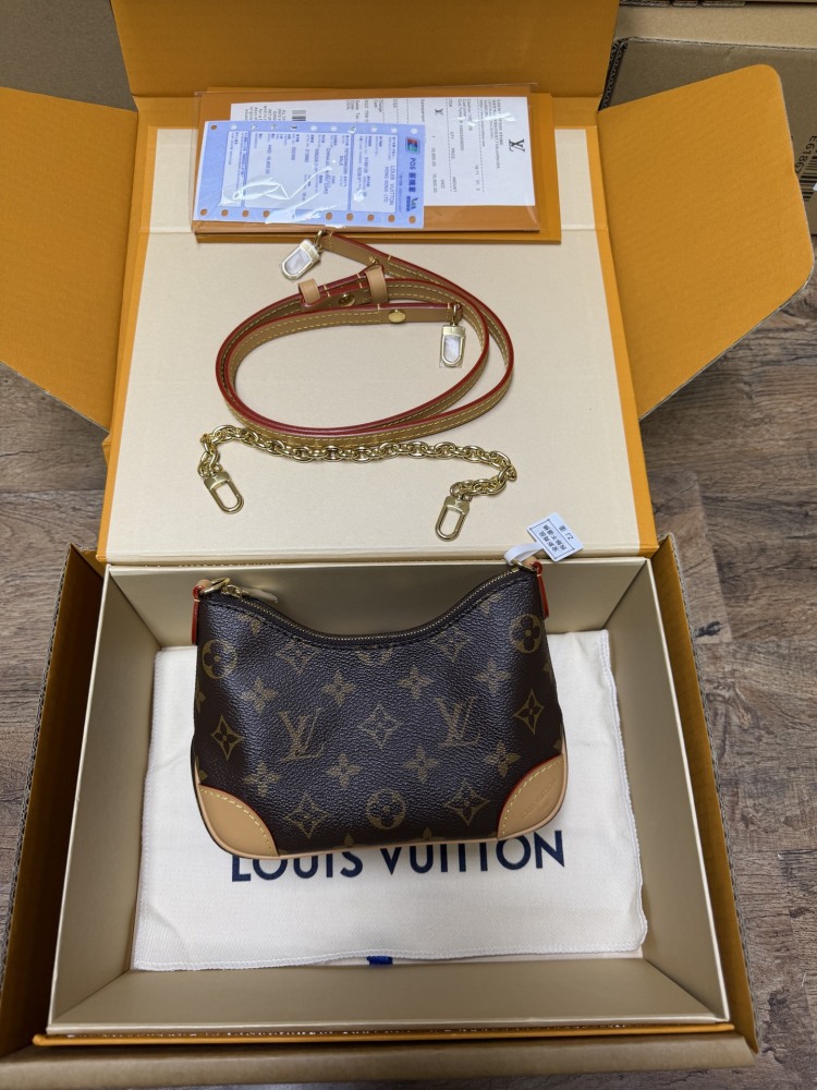 The Louis Vuitton LV Mini Hobo—often referred to as the "Moon Bag"—is crafted from the brand's classic Monogram canvas.