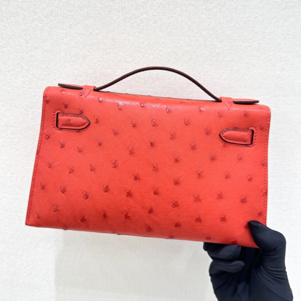 The Hermès Mini Kelly I (also known as the Kelly Pochette) Ostrich Leather Handbag is one of the brand's classic exotic leather models.