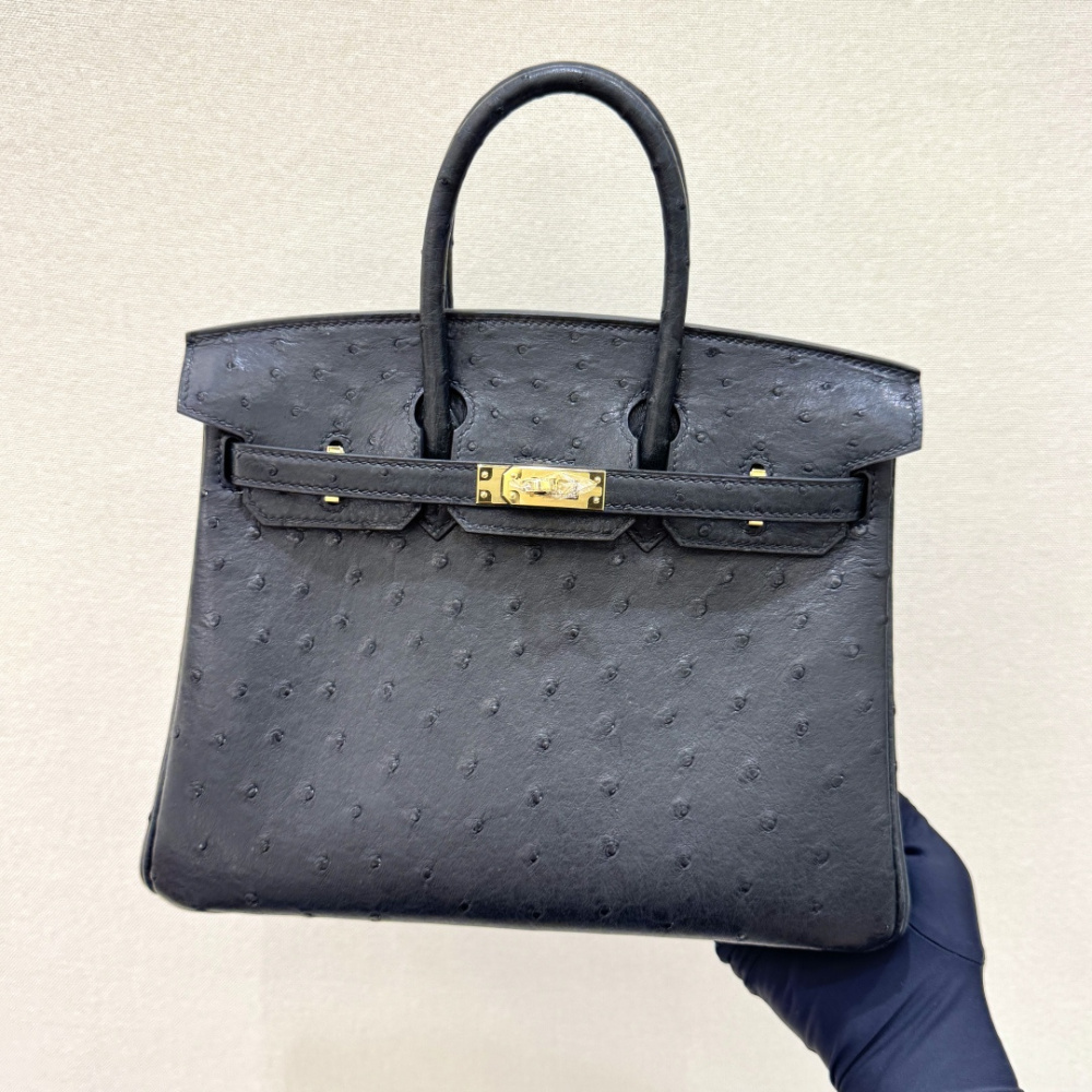 The Hermès Birkin 30 handbag in ostrich leather—featuring the classic black hue paired with gold hardware—is recognized by the brand as one of its "kings of value retention" among exotic skins.