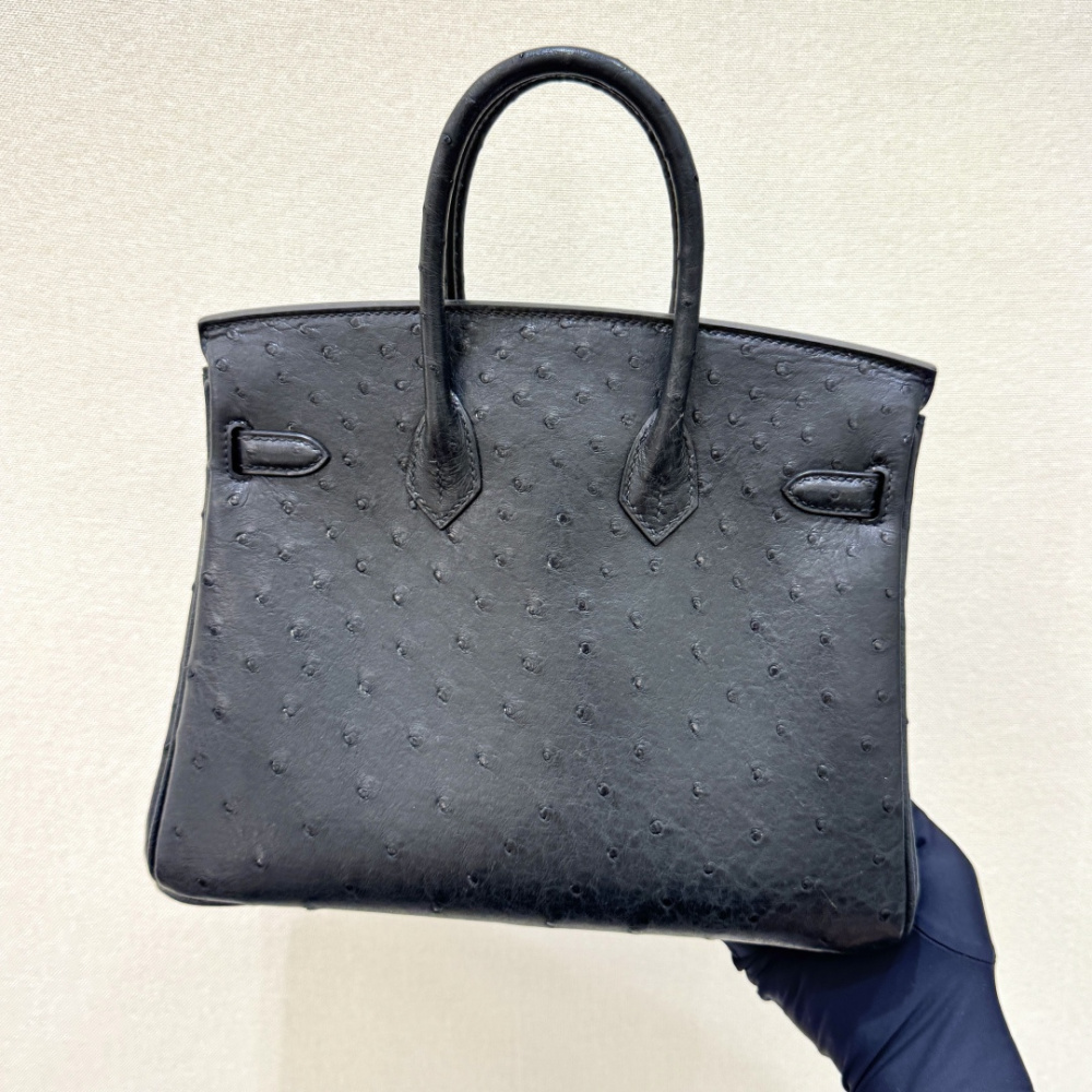 The Hermès Birkin 30 handbag in ostrich leather—featuring the classic black hue paired with gold hardware—is recognized by the brand as one of its "kings of value retention" among exotic skins.